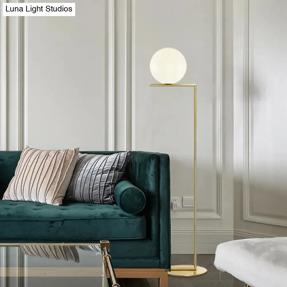 Minimalist Gold Orb Floor Lamp with Frosted Glass Shade and Right Angle Stand